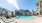 a pool in a courtyard with buildings in the background