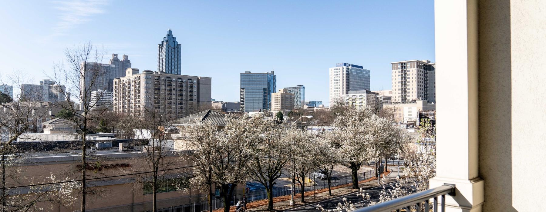 a view of a city with trees and a railing