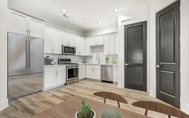 a kitchen with white cabinets