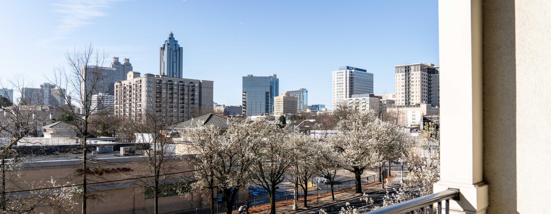 a view of a city with trees and a railing